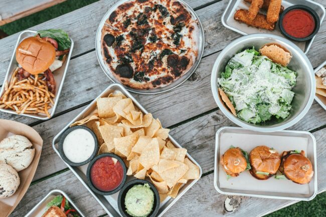 selective focus photography of plates of food on gray table